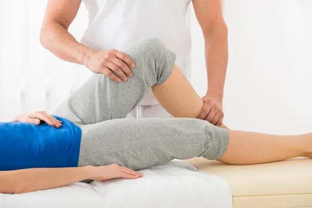 rs=w_640 A person is getting their leg examined by an osteopath.
